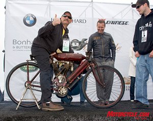 2008 legend of the motorcycle concours d elegance, Vince Martinico on the first of his four appearances on the stage He s just started his 1908 Indian Torpedo Tank Racer as Jeff Decker who chose this motorcycle for the Sculptor s Award looks on approvingly