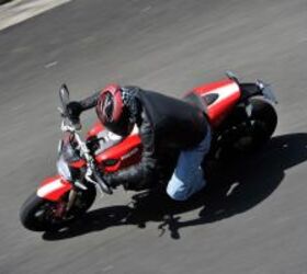 2011 ducati monster 1100 evo review motorcycle com, Both the red and black color schemes sport a wide racing stripe down the middle The red color has a white contrast while the black Monster 1100 EVO has subtler but still attractive silvery gray stripe
