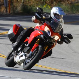 2010 ducati multistrada 1200 vs bmw r1200gs motorcycle com, At home and dominating on the pavement the Multistrada plainly exhibits Ducati sportbike heritage from which it draws heavily
