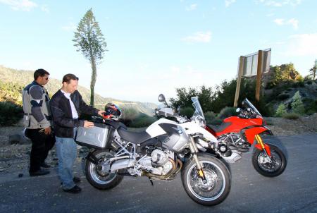 2010 ducati multistrada 1200 vs bmw r1200gs motorcycle com, Brawny Vario hard cases on the GS appear better suited for rugged off road settings as well as exhibiting a higher level of refinement than the Multi s bags