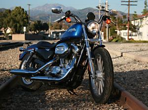 choosing your first motorcycle a beginner s guide, Despite the 883L s appearance as a big tough cruiser it posses one of the lowest seat heights in Harley s line up and is the least expensive model from the Milwaukee based company for 2010