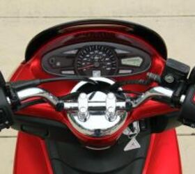 2011 honda pcx review motorcycle com, Instrumentation includes an analog speedometer and an LCD screen with fuel and trip information