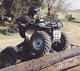atv test 1997 honda foreman 400 motorcycle com, Ample ground clearance and rugged suspension allow the Foreman to climb smoothly over obstacles