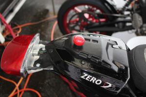 racing electric motorcycles video, The red button on the tail section is a secondary kill switch mandated by TTXGP rules Tail lights are retained and required to pulse to let others know the vehicle is on since electric motorcycles don