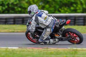 racing electric motorcycles video, Kenyon Kluge lingered in third much of the race but took his turn at the front on a few occasions and actually set the fastest time of the four in the race Note the contraption on his tail section It