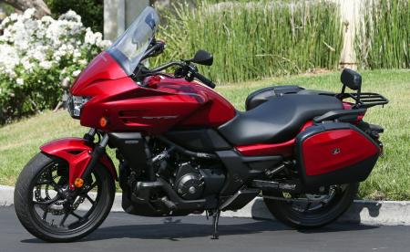 2014 honda ctx700 n review motorcycle com, A full line of accessories were developed alongside the CTXs Those who want to flesh out their entry level CTX700 into a dressed commu tourer can hook up hardshell saddlebags passenger backrest rear carrier a tall windscreen and heated grips