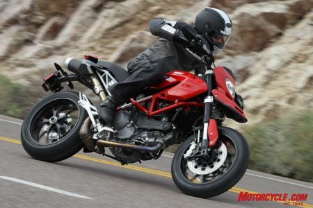 2010 ducati hypermotard 1100 evo review motorcycle com, The back end of the Hypermotard is remarkably uncluttered and the undertail exhaust allows a clear view of the exposed wheel thanks to a single sided swingarm