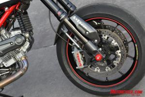 2010 ducati hypermotard 1100 evo review motorcycle com, The SP gets tasty forged aluminum wheels accented by red pinstriping Brembo monoblock brake calipers and a DLC surface treatment on its fork sliders