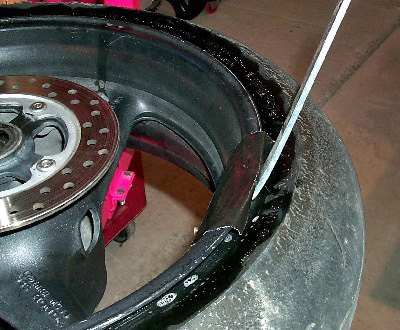 how to change your motorcycle tires motorcycle com, When you ve got a tire iron inserted between the tire and rim use it to lever the bead up and over the outside of the rim