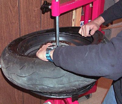 how to change your motorcycle tires motorcycle com, Once you get the bead on the upper side of the tire completely over the edge of the rim the opposite lower side should come off using just your hands