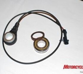 2008 harley davidson models motorcycle com, Here s the ABS sensor system in all its simplicity The larger wired piece is the sensor that reads the encoded magnet the thin brown ring exposed for display hidden away in the sealed bearing residing in the wheel hub