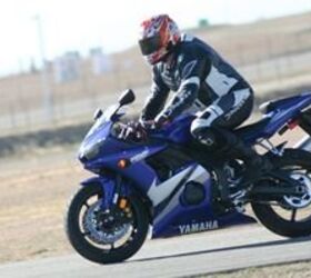 2005 yamaha r6 track test motorcycle com, Notice the compressed forks coupled with the air under Sean s butt This frame was shot mid right left transition while under very hard braking The R6 s excellent brake power and feel allows continued braking deep into this maneuver