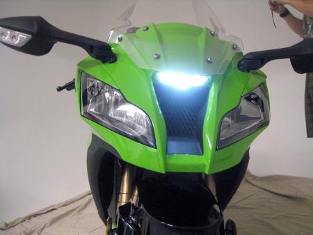2011 kawasaki zx 10r unveiled motorcycle com, Twin line beam headlights bookend a voracious ram air duct capped off by a slick LED positioning lamp