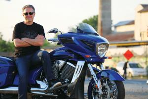2011 victory cross country review cory ness signature edition motorcycle com, Cory Ness poses on his 2012 iteration of the Victory Cross Country now in Boardwalk Blue rather than the Sunset Red 2011 version tested here