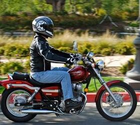 2012 honda rebel review motorcycle com, In this photo the Rebel doesn t look especially small with a rider in the saddle But looks are deceiving Though its ergonomics aren t unbearably tight Pete found its overall fit more suited to smaller riders
