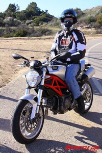 manufacturer ducati monster 1100 vs harleydavidson xr1200 review 87928, Pete sits comfortably after coming to an easy stop thanks to the radial mount Brembos that squeeze those big pie plate 320mm rotors on the Monster