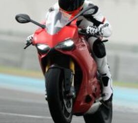 2012 ducati 1199 panigale review video motorcycle com, Accelerating onto Yas Marina s front straight in second gear it was impossible to keep the front end down when using full throttle Note the first LED headlights on a production motorcycle