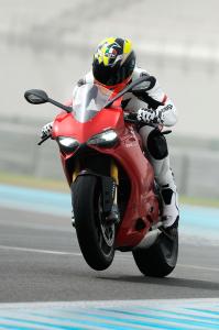 2012 ducati 1199 panigale review video motorcycle com, Accelerating onto Yas Marina s front straight in second gear it was impossible to keep the front end down when using full throttle Note the first LED headlights on a production motorcycle