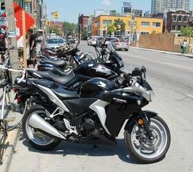 motorcycle beginner year 2 motorcycle ownership, A Honda CBR250R sits in a row of parked motorcycles across from the Motorcycle com Toronto office The little CBR did very well for Honda Canada last year and I usually see at least two or three of them on the street each day