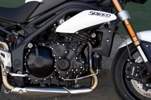 2011 triumph speed triple 1050 review motorcycle com, The same 1050cc three cylinder engine from last year remains only now it s closer to the front axle and is tilted forward for better feel from the front tire Power and torque also receive a welcome boost