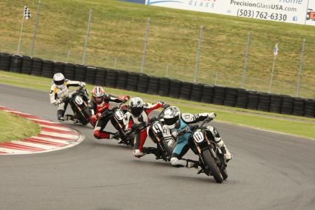 racing electric motorcycles video, I managed to jump out to an early lead in the class from the start but my attempt to break away was futile The other three riders were on me like white on rice Photo by Kent Regan