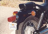 motorcycle com, Rear drum brake worked with a front disc to deliver adequate stopping power A cushy suspension but still capable enough in the turns for a cruiser