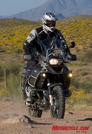 motorcycle com, The Adventure s larger fuel tank can present a challenge in tight or technical terrain with the extra weight of more fuel carried up high but if you can keep the bike marching forward it seems capable of overcoming anything in its path