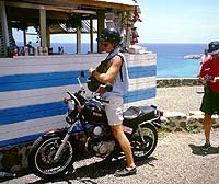 island chopping, The massive Yamaha 125 was perfect for this drive thru snack stand Notice the stylish luggage frontpack we used to carry our stuff When you re in the islands there are no worries even when you look like a dork
