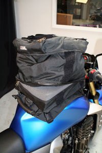 rocket touring gear roundup, The bottom most compartment is meant to hold toolkits and other hard items using a cushion of foam to prevent damage to your tank You could stuff folded clothing in there too