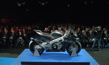 aprilia unveils rsv 4 race machine in milan, Wow Look at all those stodgy characters in the background Is this a dealer meeting or a gathering of the MJ 12 All that carbon Kevlar looks great though Aprilia Back in big bike racing Yeah
