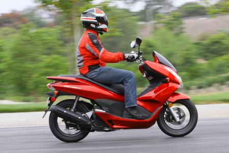 2013 honda pcx150 review motorcycle com, Taller riders may find themselves sitting in the pillion seat to ride the PCX though the long sweeping floorboards provide plenty of legroom
