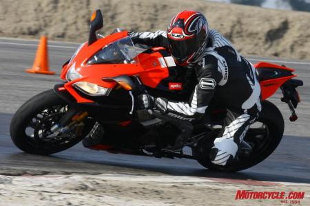2010 aprilia rsv4 factory review motorcycle com, The RSV4 s handling is biased toward its wonderful feeling front end encouraging its rider to drop his inside shoulder to carve corners with the trustworthy feel from the tire said Duke