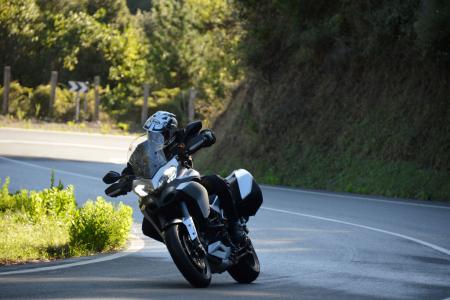 2013 ducati multistrada 1200 s touring review motorcycle com, Damp corner exits are no match for the Multistrada s traction control system and the V Twin s newfound gentleness at low revs