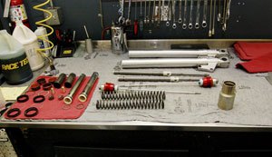 road racing series part 6, The Ducati s Showa front lies disassembled on a Race Tech workbench awaiting rebuild Race Tech also sells its components to intrepid garage mechanics who want to rebuild their suspension on their own Photo courtesy of Race Tech