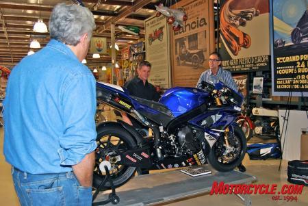 yamaha throws laguna seca motogp warm up party in jay leno s garage, Yamaha s Bob Starr along with Chuck Graves unveil the R1 factory superbike a gift from Yamaha to Jay Leno