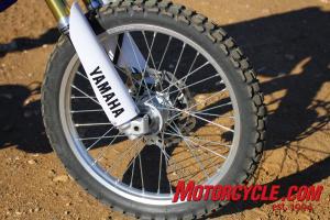 2011 yamaha wr250r review motorcycle com, The 21 inch front on off road knobby is stopped by a single piston caliper squeezing a 250mm slotted wave rotor