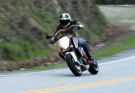 2013 ktm 690 duke review video motorcycle com, The KTM 690 Duke s smiles per gallon rating is almost as good as it gets as long as the journey isn t a very long one