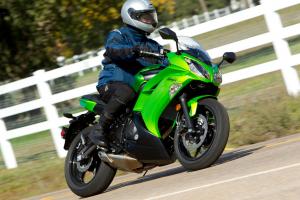 2012 kawasaki ninja 650 review first ride video motorcycle com, The Green Ninja 650 features matte black airbox covers and a silver painted shock spring The red Ninja has color matched covers and a red shock spring for the same MSRP