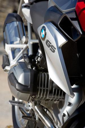 2013 bmw r1200gs review video motorcycle com, The R1200 engine is entirely new now with intakes above the cylinder head but the Boxer still retains cooling fins to disperse heat The chromed plastic radiator surrounds employ nano technology to inhibit fingerprints