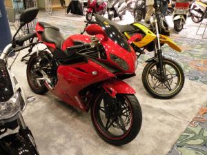 2010 indy dealer expo report, Bennche is a new nameplate that loosely means swift in Chinese The red Megelli 250R is flanked on the right by the Megelli 250M