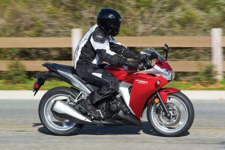 2011 honda cbr250r tech review motorcycle com, Family resemblance to the VFR1200F particularly for the red silver version is evident Honda says riders from 5 feet 4 inches tall up to 6 foot 2 fit well with maybe some room remaining on either extreme
