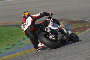 2011 aprilia tuono v4r aprc review motorcycle com, The Tuono V4R APRC leans into the corners like a superbike
