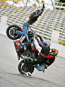 2007 daytona stunta report, Josh Crazy Conway of the Orlando based Warped Toys stunt team performs a wheelie with two passengers at Stunt Fury 2007 held during Daytona Bike Week