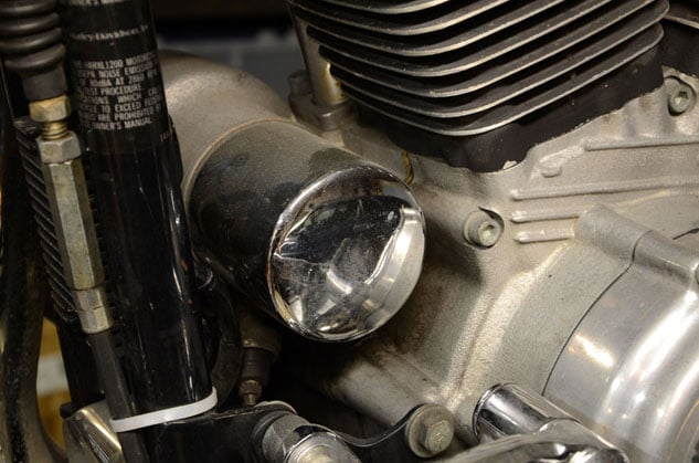 how to change oil in a harley davidson, The oil filter of a Harley Davison Sportster is located just behind the downtubes and immediately in front of the cases and front cylinder of the motor Usually the filters are chrome or black but occasionally they are white