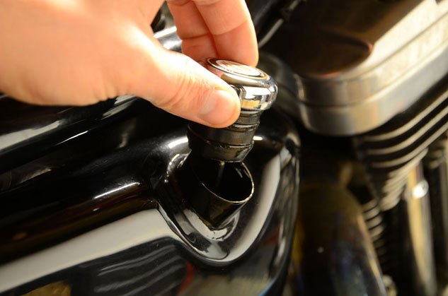 how to change oil in a harley davidson, Start the oil change by venting the system and remove the oil filler cap from the oil tank located on the right side of the bike underneath the seat