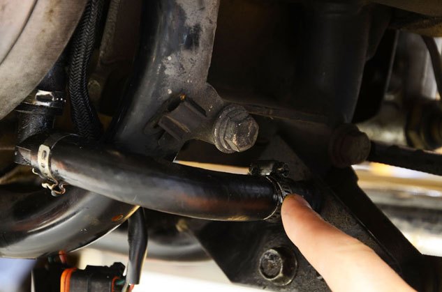 how to change oil in a harley davidson, Next find the drain tube It helps to use a frame jack for tool access underneath the bike but it is not required There is a hose with a screw type hose clamp attached to it all the other hose connections are crimped just behind the primary and in front of the rear tire