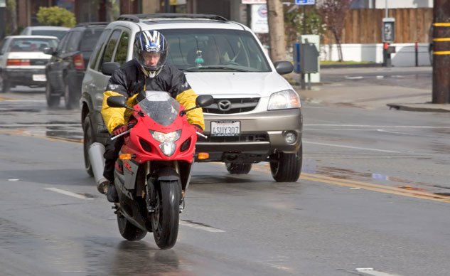 proper motorcycle lane positioning, This rider has placed himself in a position to be more visible to the driver If the car is overtaking the motorcycle moving to the right would increase the space cushion as the car passed