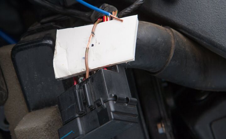 turn on how to install switched accessory power to your motorcycle, The insulation has been removed from the wire from which you plan on stealing a little power The cardboard protects the rest of the wiring harness from inadvertent damage from the soldering iron