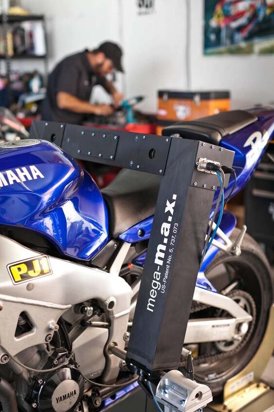 2000 yamaha r1 a garage space odyssey, The German built MegaMax device measures a frame with no disassembly required It slips into the swingarm pivot and uses lasers to determine straightness Or lack of