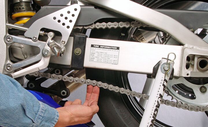 how to adjust a motorcycle chain, Check the chain s slack at the midpoint between the sprockets Measure in several places to find the chain s tightest section